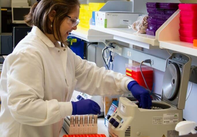 Lab Scientist with Balance Scientist Moisture Balance